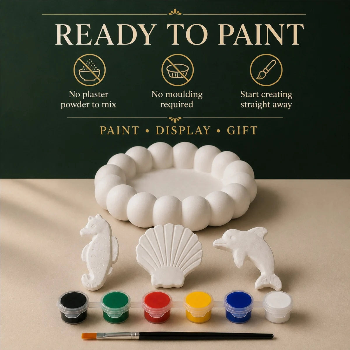 The pieces being painted at a table