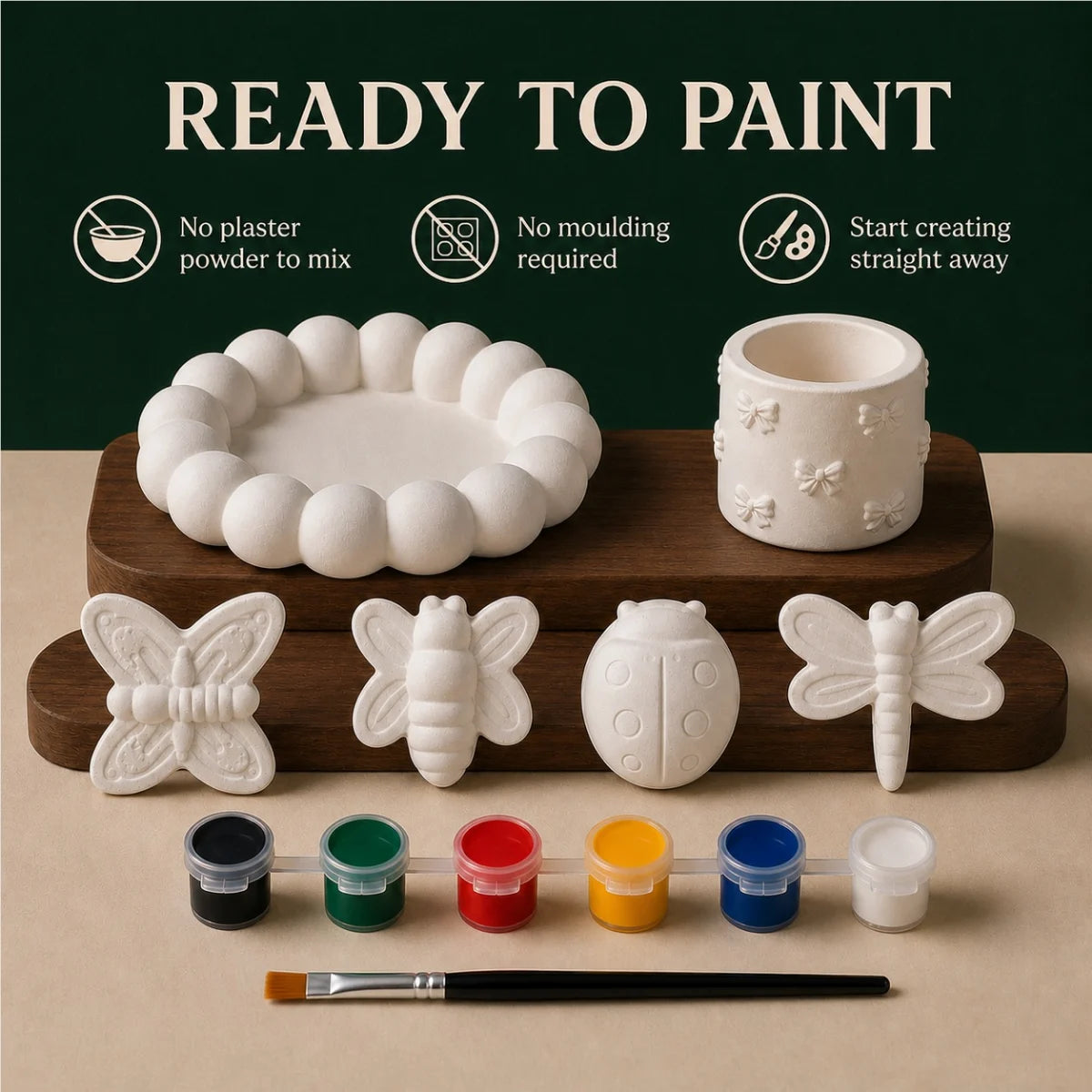 The pieces being painted at a table