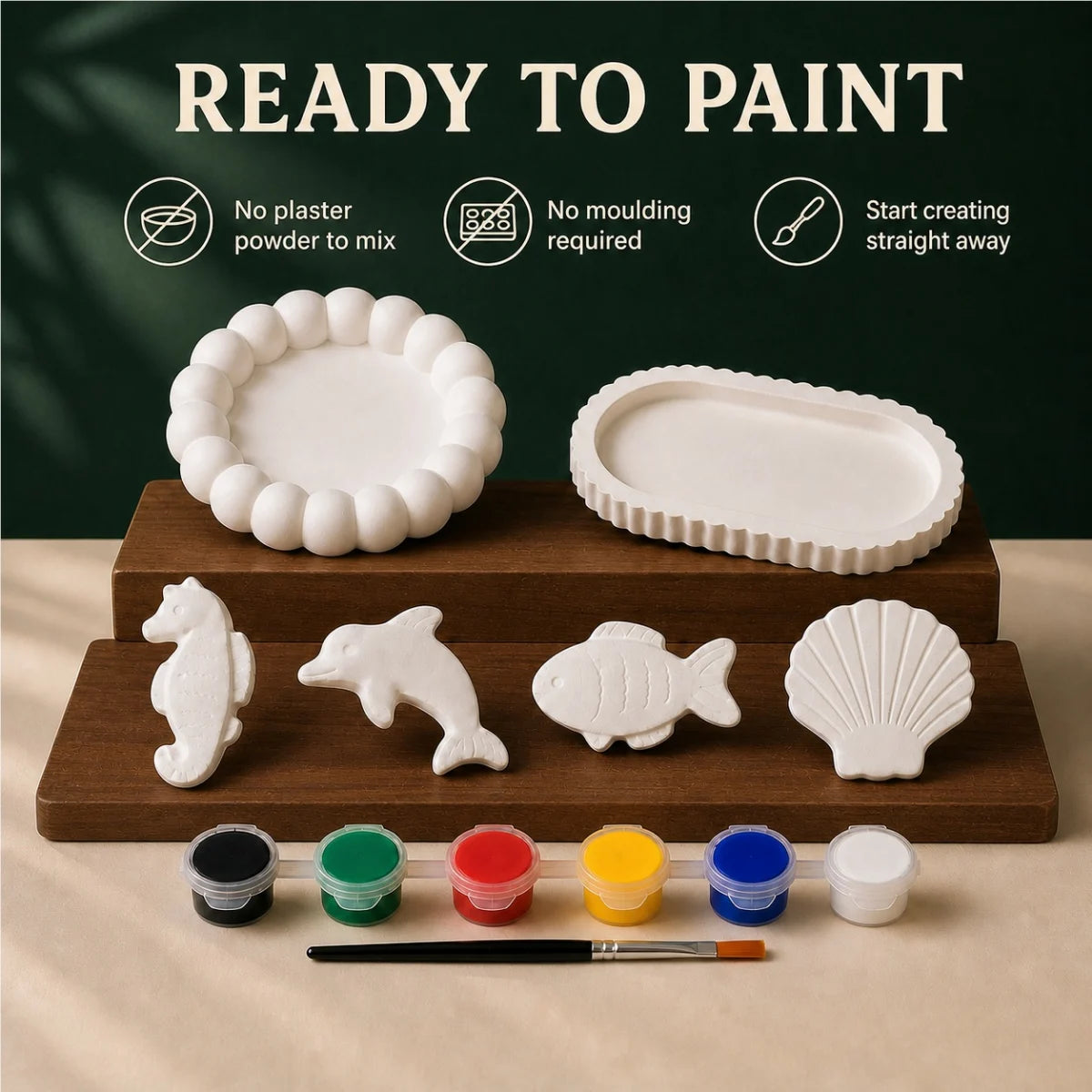The pieces being painted at a table