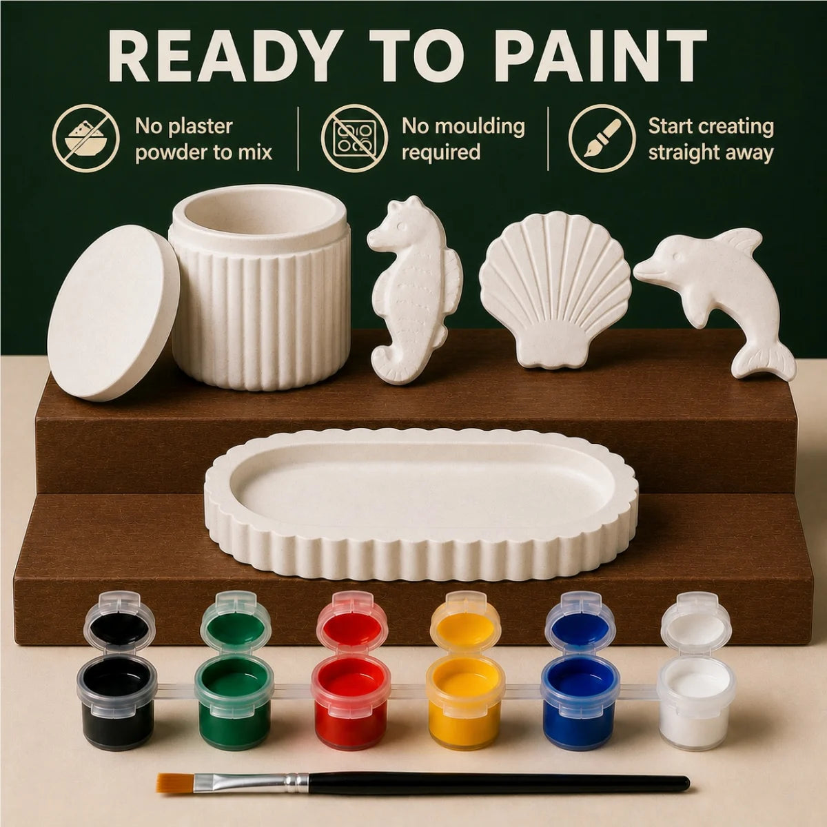 The pieces being painted at a table