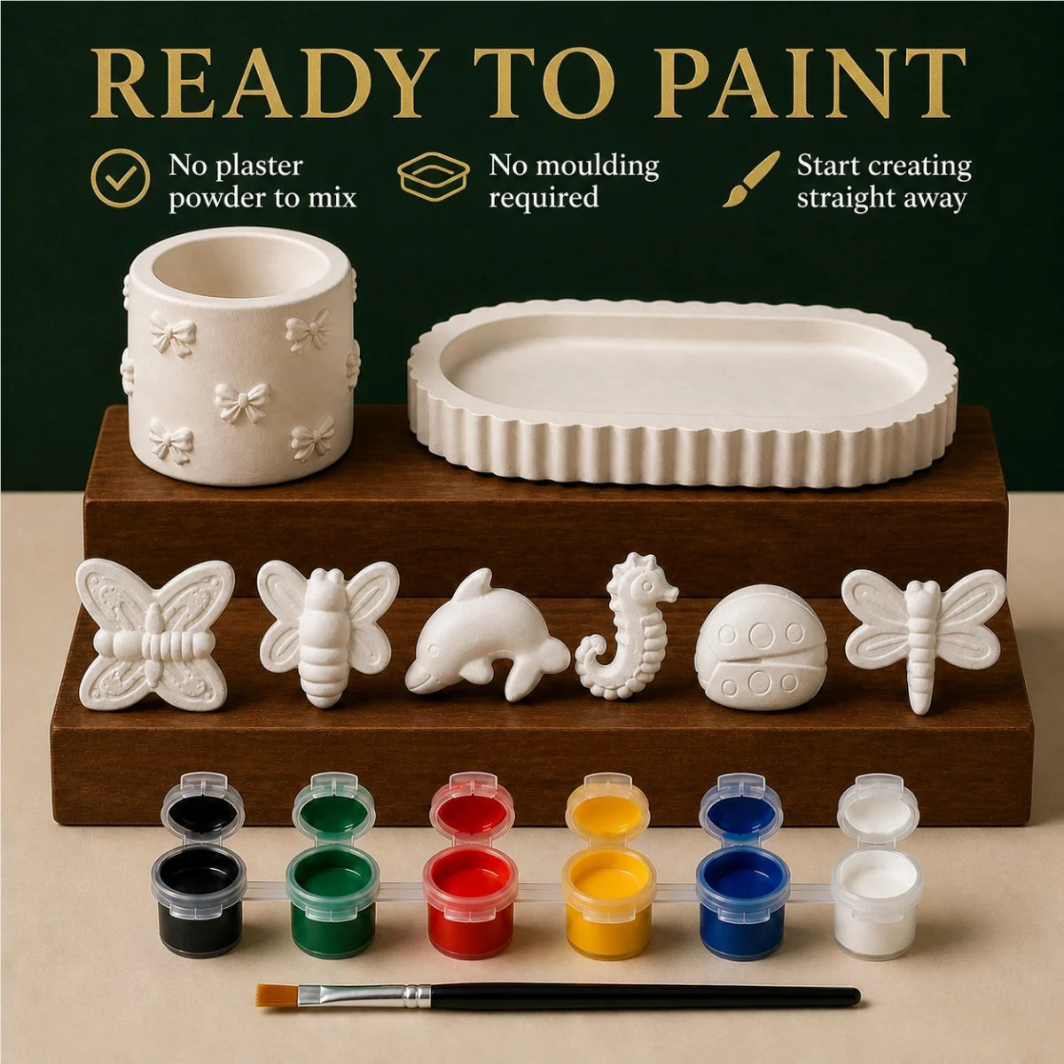 The pieces being painted at a table